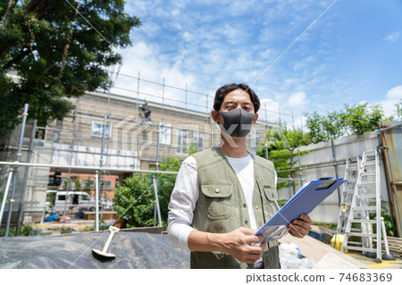 Male worker working at the construction site Male worker working at the construction site 74683369