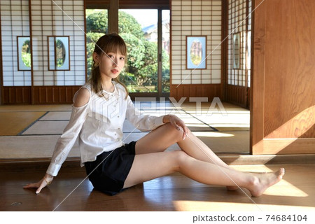 A young and slim woman relaxing in a Japanese-style room in an old folk house A young and slim woman relaxing in a Japanese-style room in an old folk house 74684104