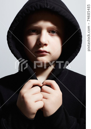 little boy in black hoodie. teenager boy. Child 74685485
