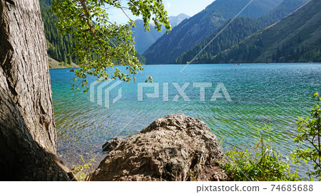 Mountain lake Kolsay with floating boats. Mountain lake Kolsay with floating boats. 74685688