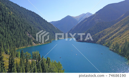 Kolsay lake among green hills and mountains. 74686190