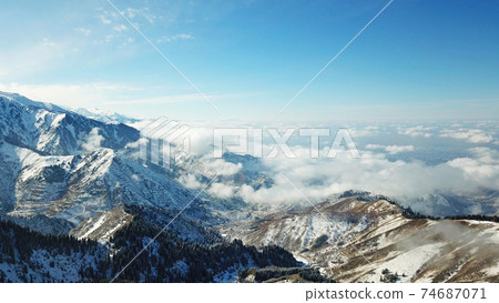Snow forest in the mountains, above the clouds. Snow forest in the mountains, above the clouds. 74687071