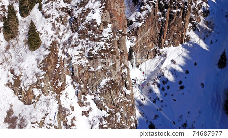 Freezing waterfall in the snowy mountains. Freezing waterfall in the snowy mountains. 74687977