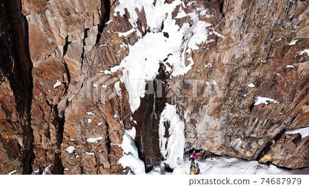 Freezing waterfall in the snowy mountains. Freezing waterfall in the snowy mountains. 74687979