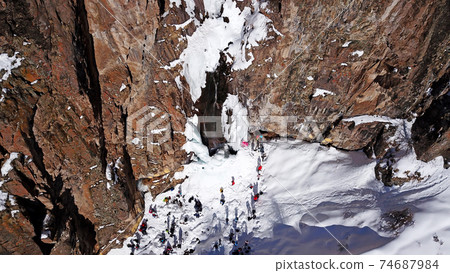 Freezing waterfall in the snowy mountains. Freezing waterfall in the snowy mountains. 74687984