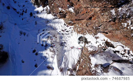 Freezing waterfall in the snowy mountains. Freezing waterfall in the snowy mountains. 74687985
