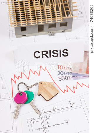Keys, inscription crisis, euro and downward graphs representing crisis of real estate market 74688203