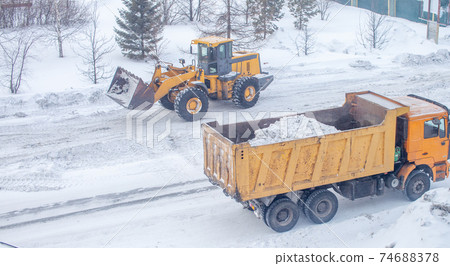 Cleaning and cleaning of roads in the city from snow in winter Cleaning and cleaning of roads in the city from snow in winter 74688378