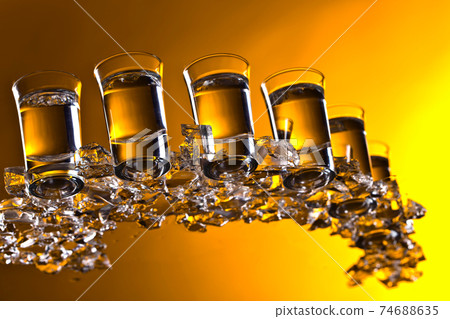 Glasses of vodka with ice. Glasses of vodka with ice. 74688635