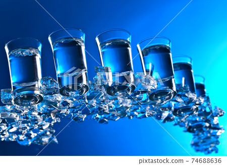 Glasses of Russian vodka with ice. Glasses of Russian vodka with ice. 74688636
