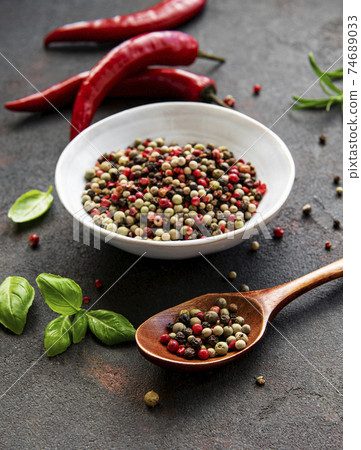 Red hot chili pepper corns and pods on dark background, top view Red hot chili pepper corns and pods on dark background, top view 74689033