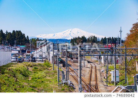 Mt. Chokai and railroad tracks with residual snow Mt. Chokai and railroad tracks with residual snow 74689842