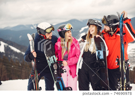 People snowboarding in the mountains with the snowboard 74690978