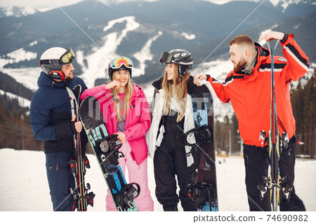 People snowboarding in the mountains with the snowboard People snowboarding in the mountains with the snowboard 74690982
