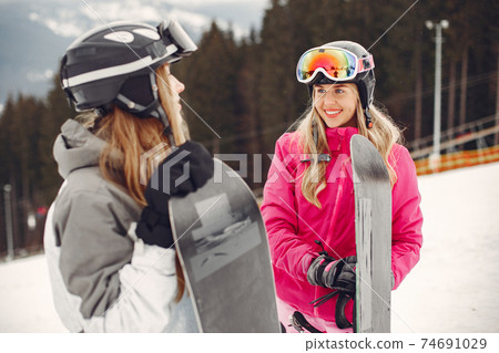 Girls snowboarding in the mountains with the snowboard 74691029