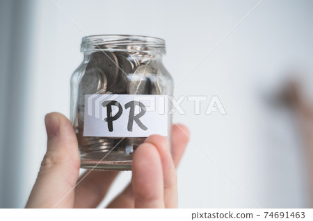 Savings concept for PR - Glass jar with coins and inscription. 74691463