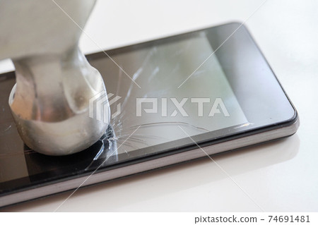 Smartphone display repair concept - abstract smash with a hammer. 74691481