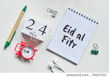 Eid al Fitr Festival of Breaking the Fast is a religious holiday celebrated by Muslims - 24 twenty fourth May Month Calendar Concept on Wooden Blocks. 74691505