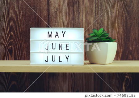 May, June, July word in light box on wooden background May, June, July word in light box on wooden background 74692182