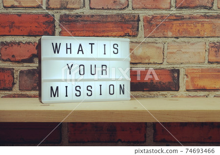 What is your mission word in light box on brick wall and wooden shelves background What is your mission word in light box on brick wall and wooden shelves background 74693466