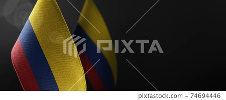 Small national flags of the Colombia on a dark background 74694446