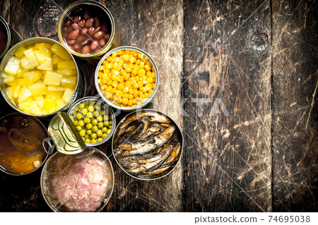Various canned vegetables, meat, fish and fruits in tin cans. Various canned vegetables, meat, fish and fruits in tin cans. 74695038
