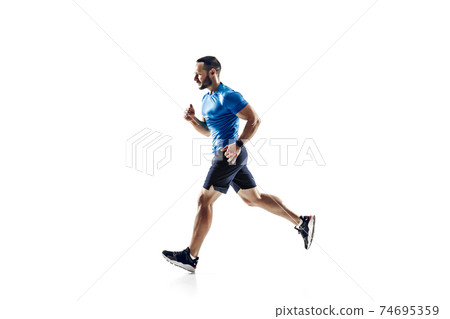 Caucasian professional male runner, athlete training isolated on white studio background. Copyspace for ad. Caucasian professional male runner, athlete training isolated on white studio background. Copyspace for ad. 74695359