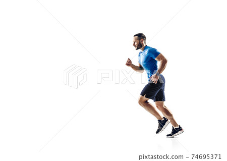 Caucasian professional male runner, athlete training isolated on white studio background. Copyspace for ad. Caucasian professional male runner, athlete training isolated on white studio background. Copyspace for ad. 74695371