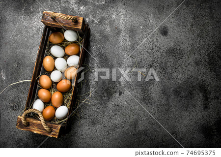 Fresh eggs in an old box. Fresh eggs in an old box. 74695375