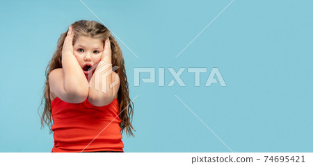 Happy caucasian little girl isolated on studio background. Looks happy, cheerful, sincere. Copyspace. Childhood, education, emotions concept Happy caucasian little girl isolated on studio background. Looks happy, cheerful, sincere. Copyspace. Childhood, education, emotions concept 74695421