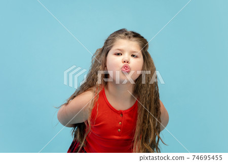Happy caucasian little girl isolated on studio background. Looks happy, cheerful, sincere. Copyspace. Childhood, education, emotions concept Happy caucasian little girl isolated on studio background. Looks happy, cheerful, sincere. Copyspace. Childhood, education, emotions concept 74695455