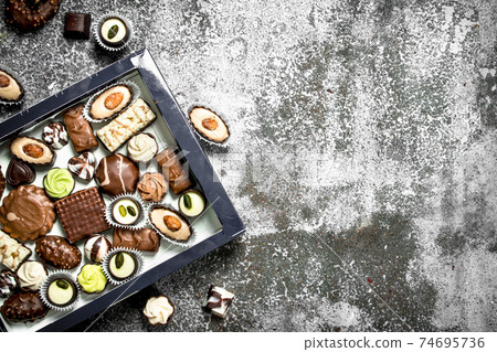 Chocolate sweets in box. 74695736