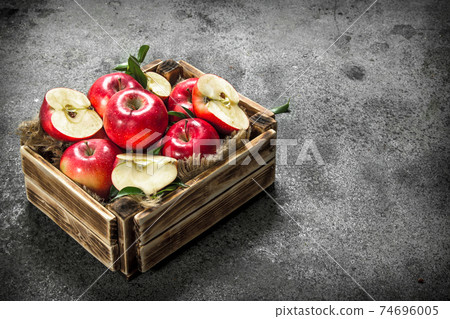 box with ripe red apples. 74696005