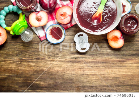 Baby food. Baby puree from fresh plums. 74696013