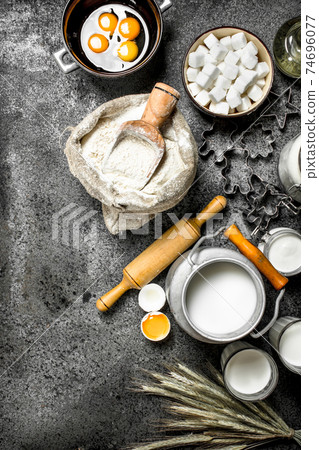 Baking background. Milk, flour and other ingredients for the dough. 74696077