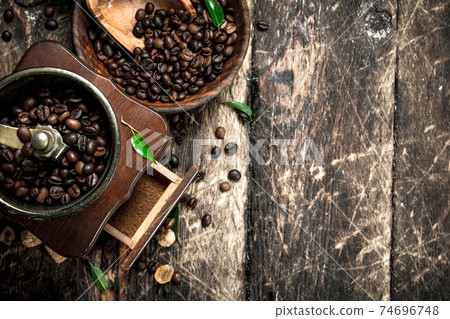 Coffee grinder with coffee beans. Coffee grinder with coffee beans. 74696748