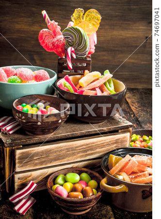 Different sweet candy, jelly, marshmallows and candied fruits. Different sweet candy, jelly, marshmallows and candied fruits. 74697041