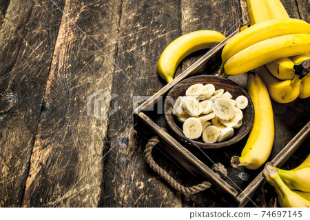 Sliced ripe banana in a bowl. 74697145