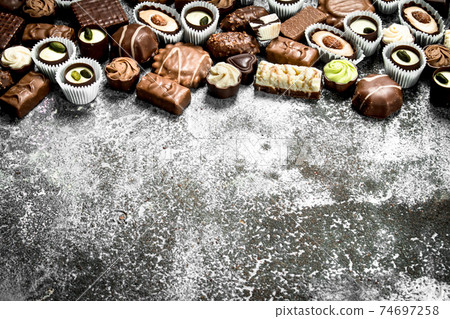 Chocolate candies. On rustic background. Chocolate candies. On rustic background. 74697258