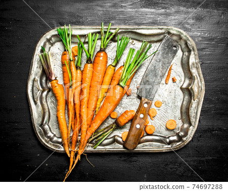 Organic food. Fresh carrots on a steel tray. Organic food. Fresh carrots on a steel tray. 74697288