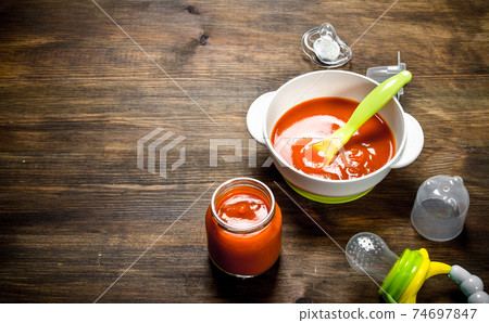Baby food. Baby puree carrot with a nipple. Baby food. Baby puree carrot with a nipple. 74697847
