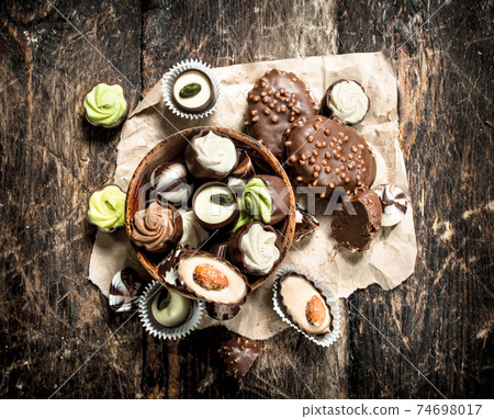 Chocolate candies in a bowl. Chocolate candies in a bowl. 74698017