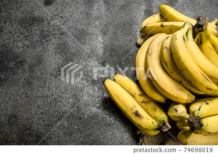 Fresh bunches of bananas. 74698019