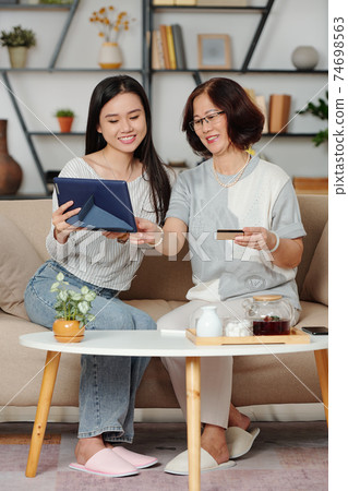 Mother and daughter shopping online Mother and daughter shopping online 74698563