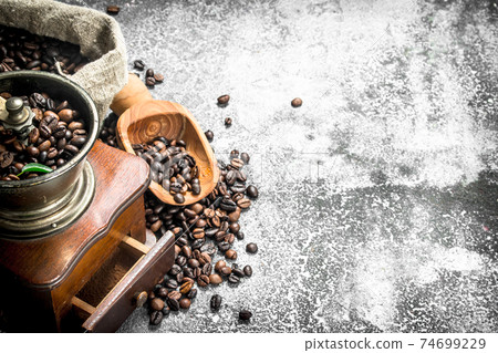 hand grinder with coffee beans. 74699229