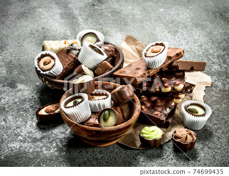 Chocolate candies in a bowls. Chocolate candies in a bowls. 74699435