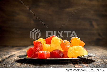 Fruit candies on a steel tray. 74699777
