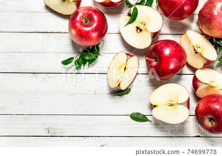 Fresh red apples with leaves. 74699778