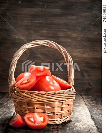 Fresh tomatoes in a basket. 74699985