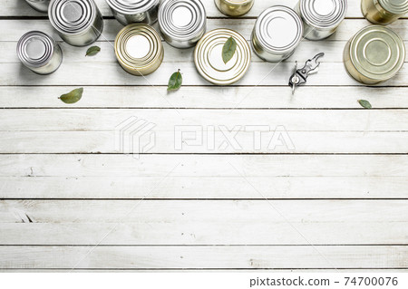 Tin cans with food and opener. 74700076